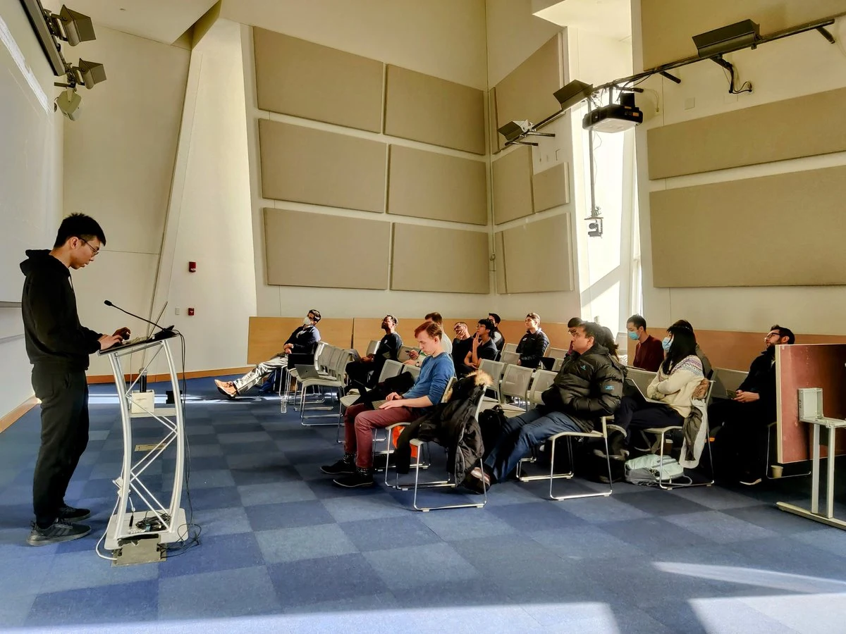 Participants listen to a speaker during the MIT AI for Code and Science Workshop.