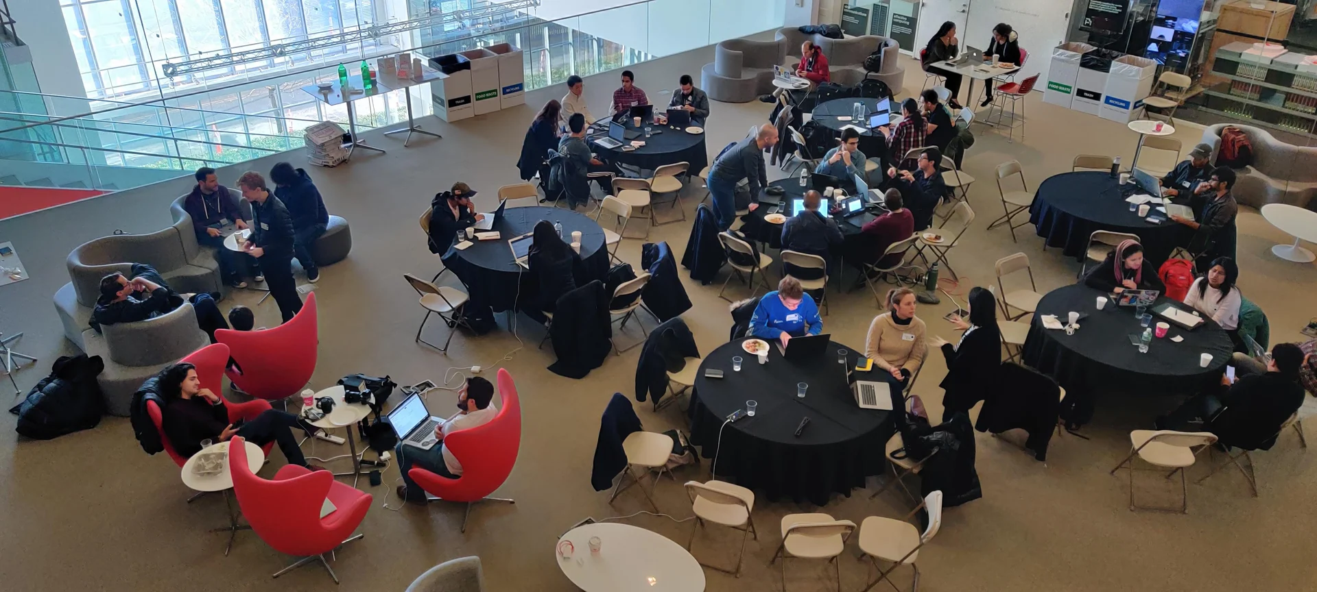 Participants work together around tables during the AI Latin American SumMIT Hackathon at the MIT Media Lab, January 24, 2020.