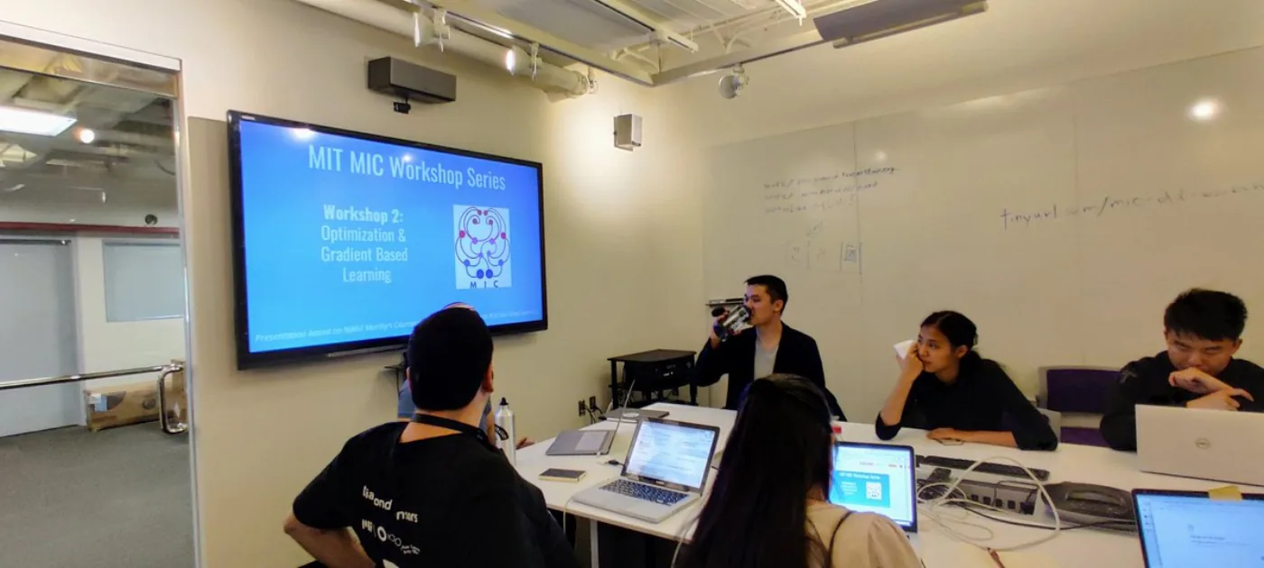 Hackathon participants work through an optimization and gradient-based learning workshop at MIT.