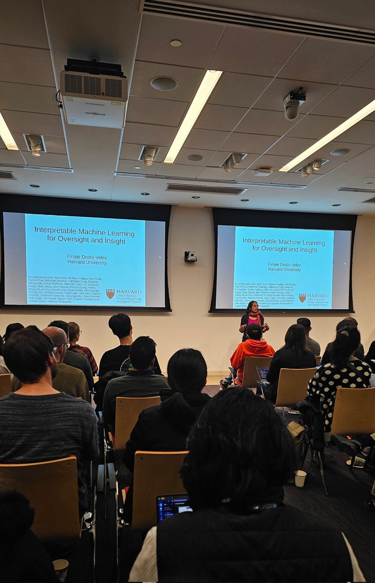 Audience members listen to a speaker at the Broad Institute talk on interpretable machine learning.