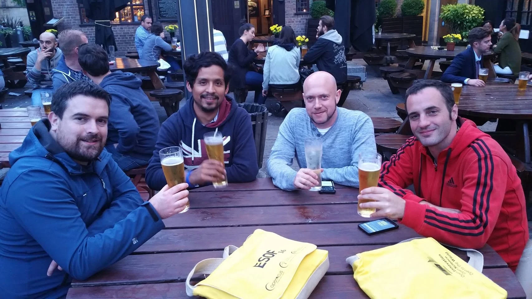 Conference attendees gather around an outdoor table during ESOF 2016 in Manchester.