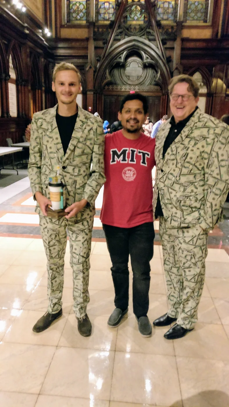 Dr. Omar Costilla Reyes stands between 2019 Ig Nobel Economics Prize recipients Timothy A. Voss (left) and Andreas Voss (right) at Harvard University.