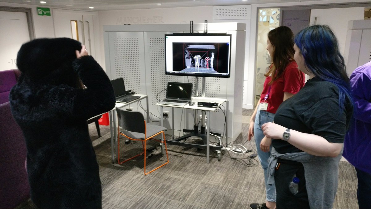 Workshop participants watch a movement-sensing demonstration at the University of Manchester DigiLab.