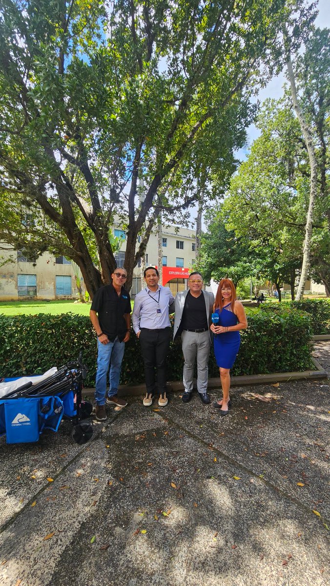 Four adults gathered outdoors near a campus building during the March 2025 Puerto Rico project introduction.