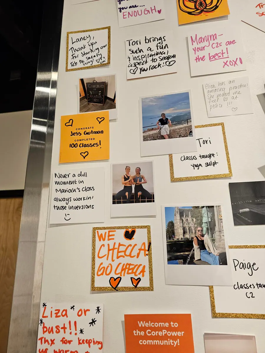 A CorePower Yoga community wall filled with class notes and snapshots.
