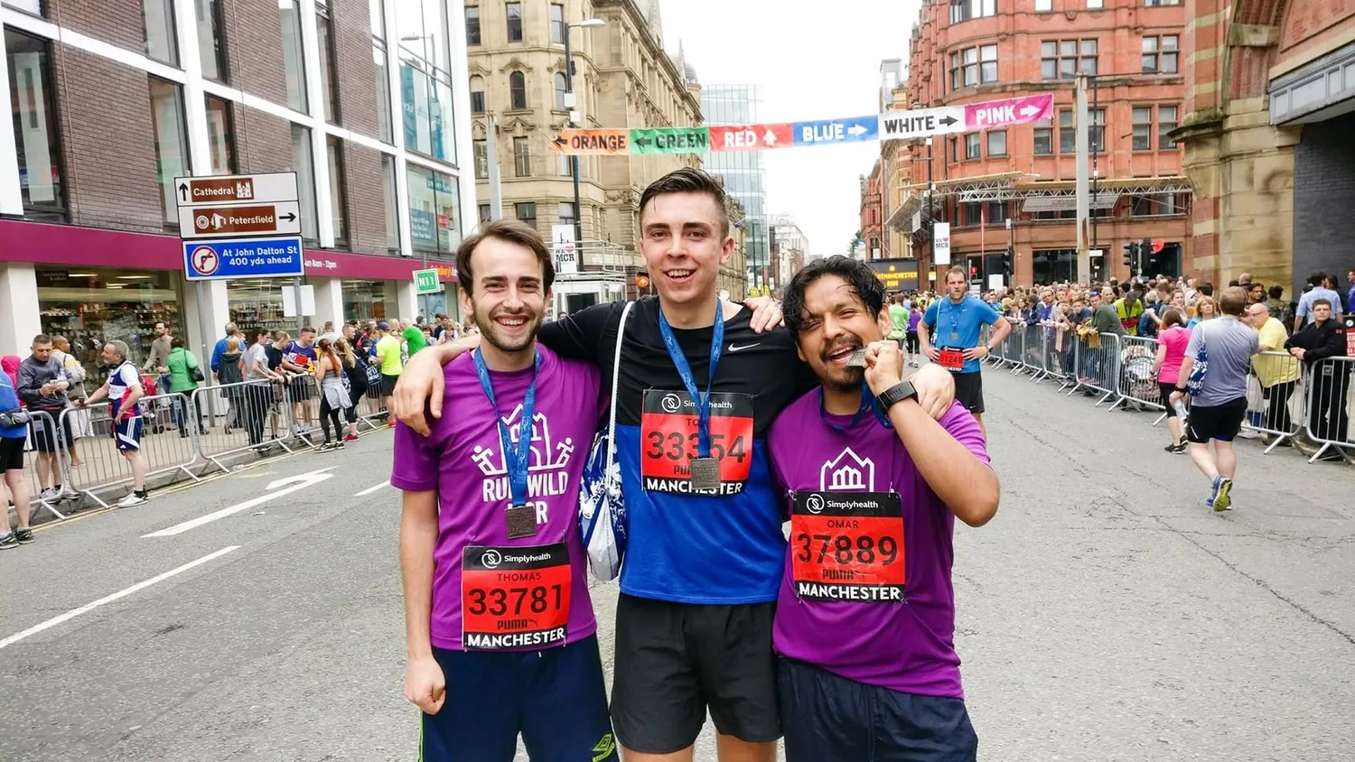 Runners wearing their medals after the Manchester Half Marathon in 2017.