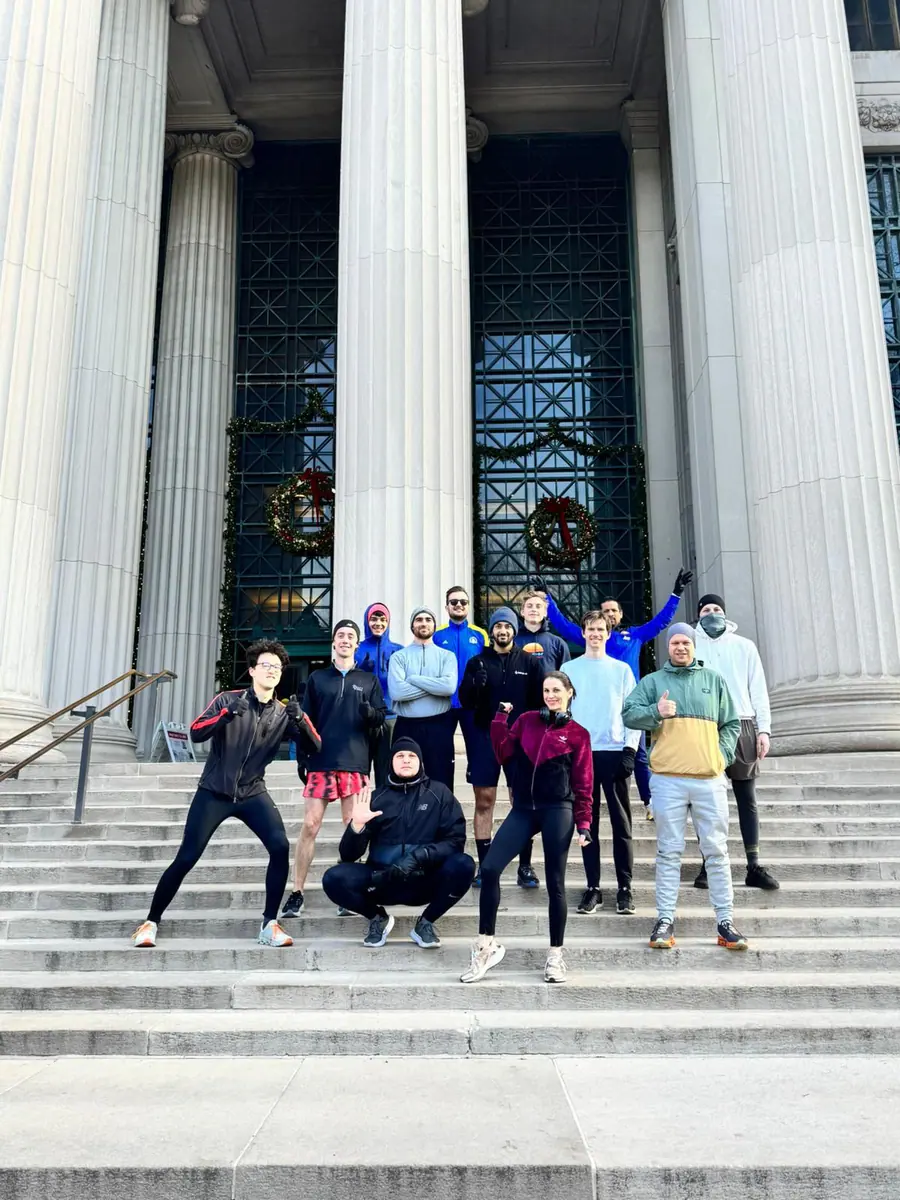Members of the MIT Postdoctoral Association running group gather outside.