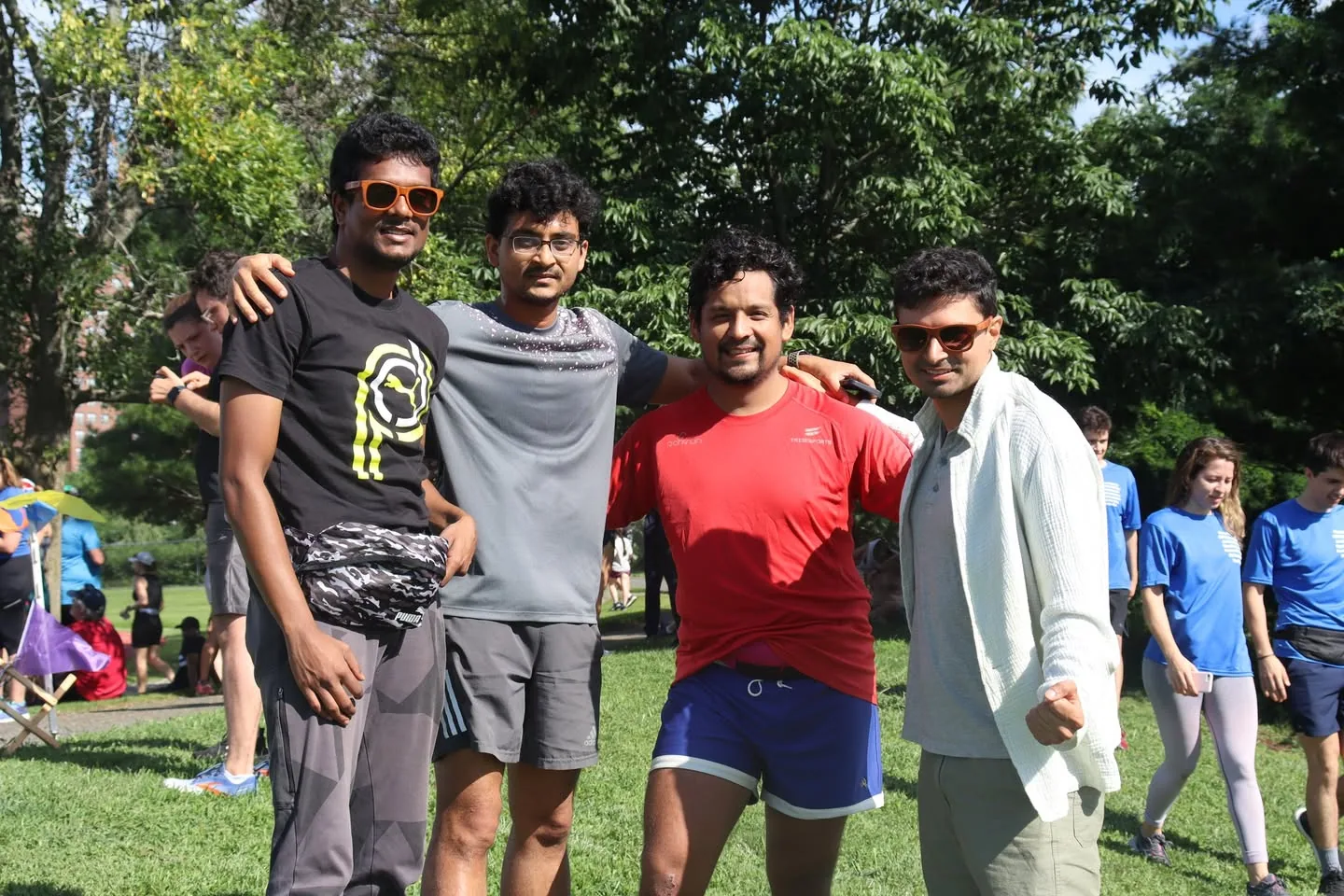 A small group celebrating a 100th parkrun milestone in 2023.
