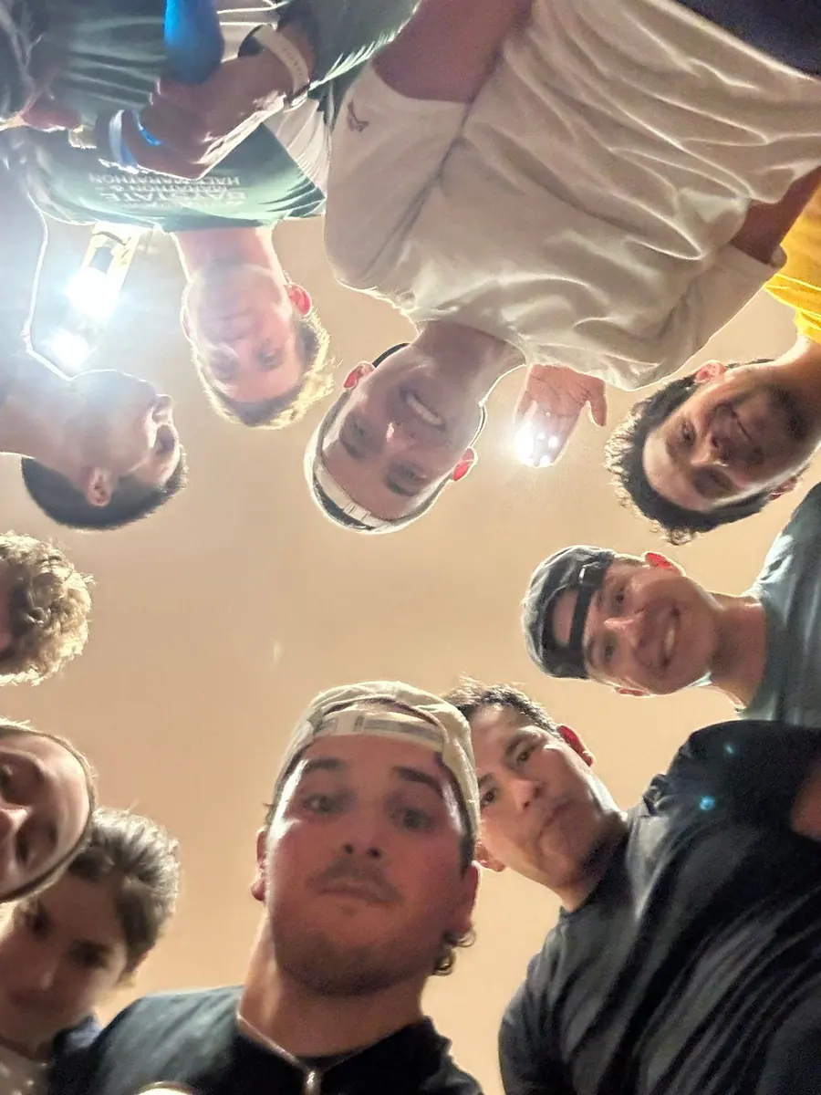 Omar and running friends lean in for a group selfie in Boston.